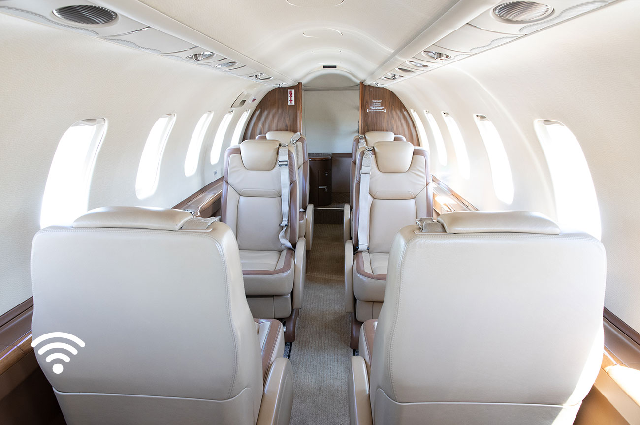 Image of the interior of the InternationAirCharters Learjet 45 looking to the rear of the plane and noting wifi enabled.